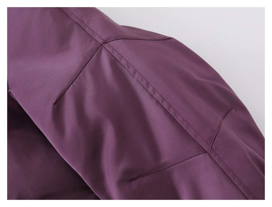 Close-up of the plum-purple jacket sleeve, showing curved stitched panel seams.