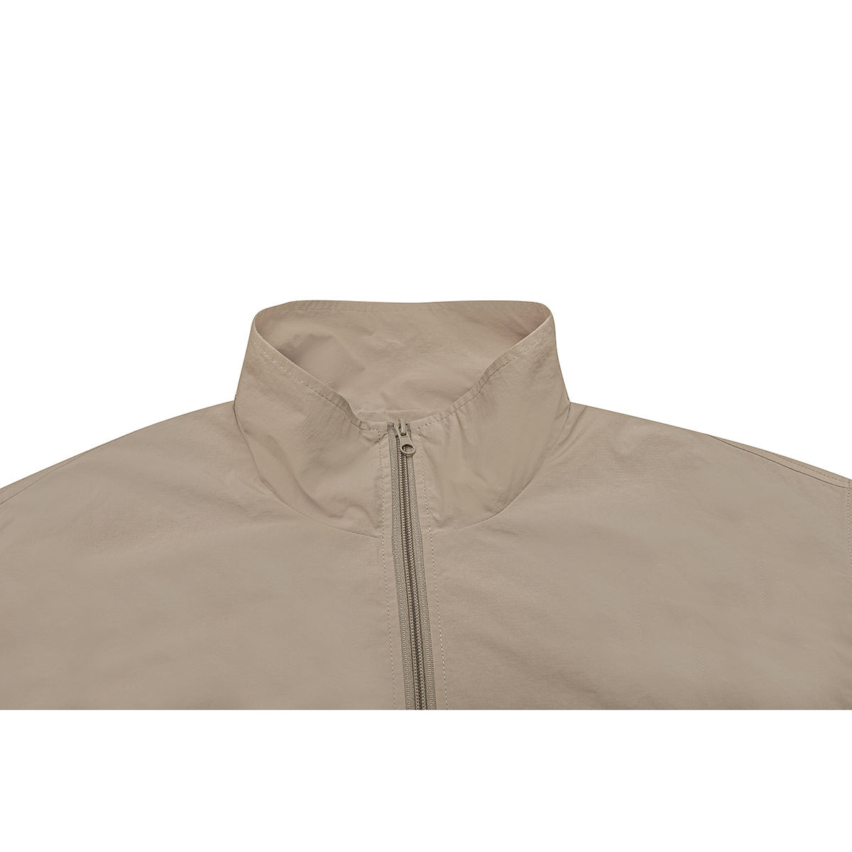 Close-up of a beige jacket's tall stand collar and centered zipper.