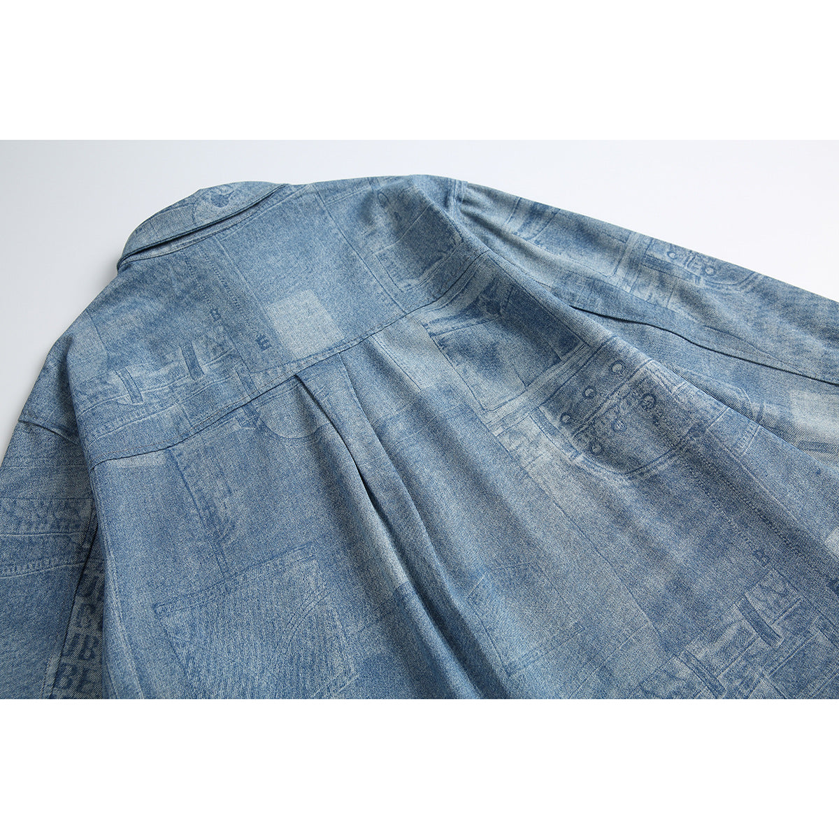 Back view of a light blue patterned button-up shirt laid flat, showing the yoke, shoulder seams, and center pleat.