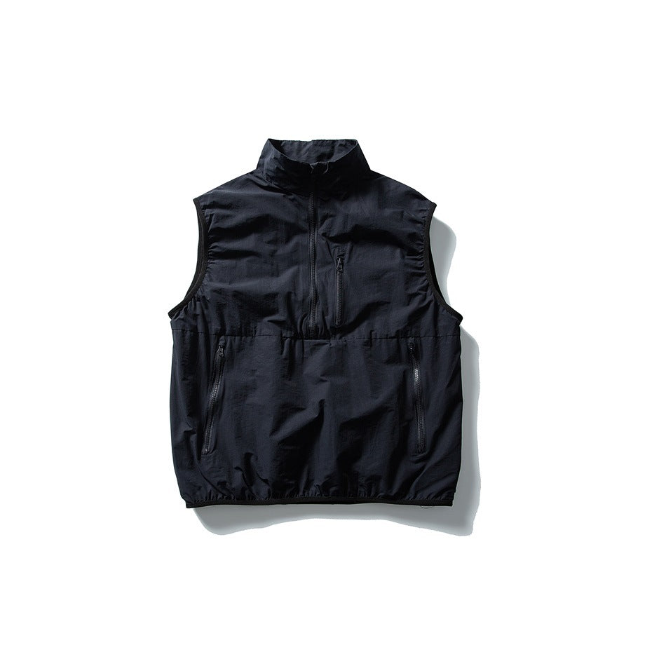 Dark navy half-zip stand-collar vest with zippered chest and lower front pockets, flat front view