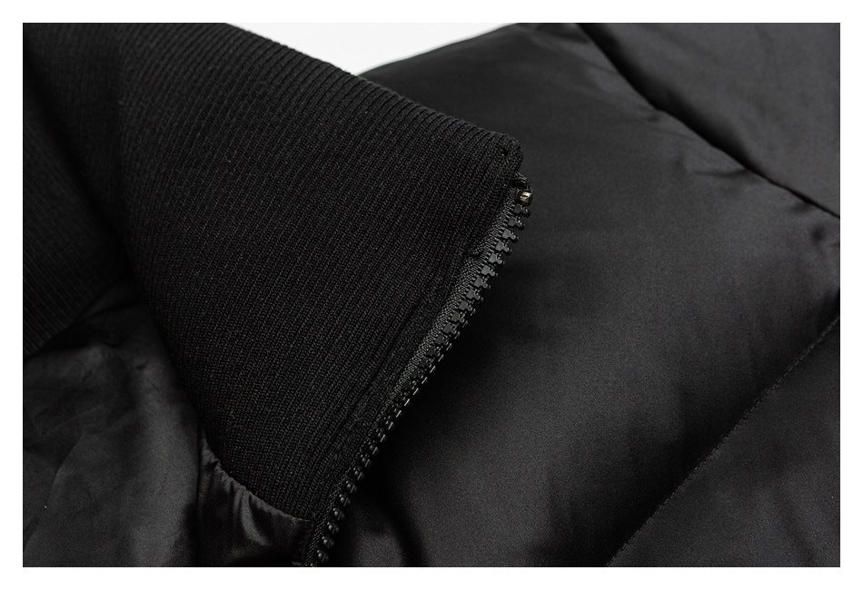 Close-up of ribbed black knit trim, zipper teeth, and a padded garment panel.