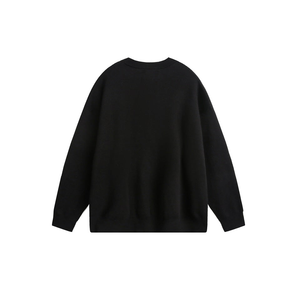 Back view of a plain black crewneck sweater with long sleeves and ribbed cuffs and hem.