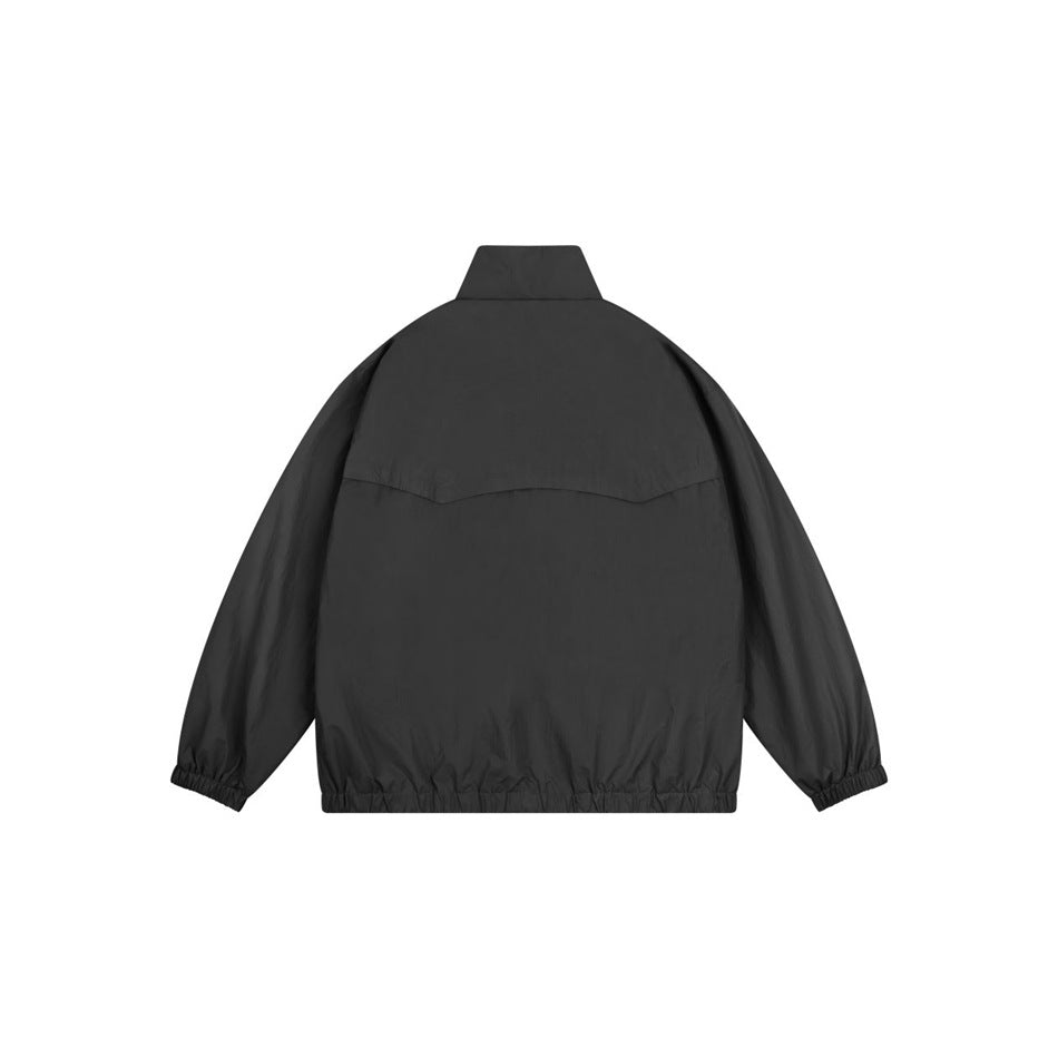Back view of a black stand-collar jacket with a curved upper-back seam and elasticated cuffs and hem.