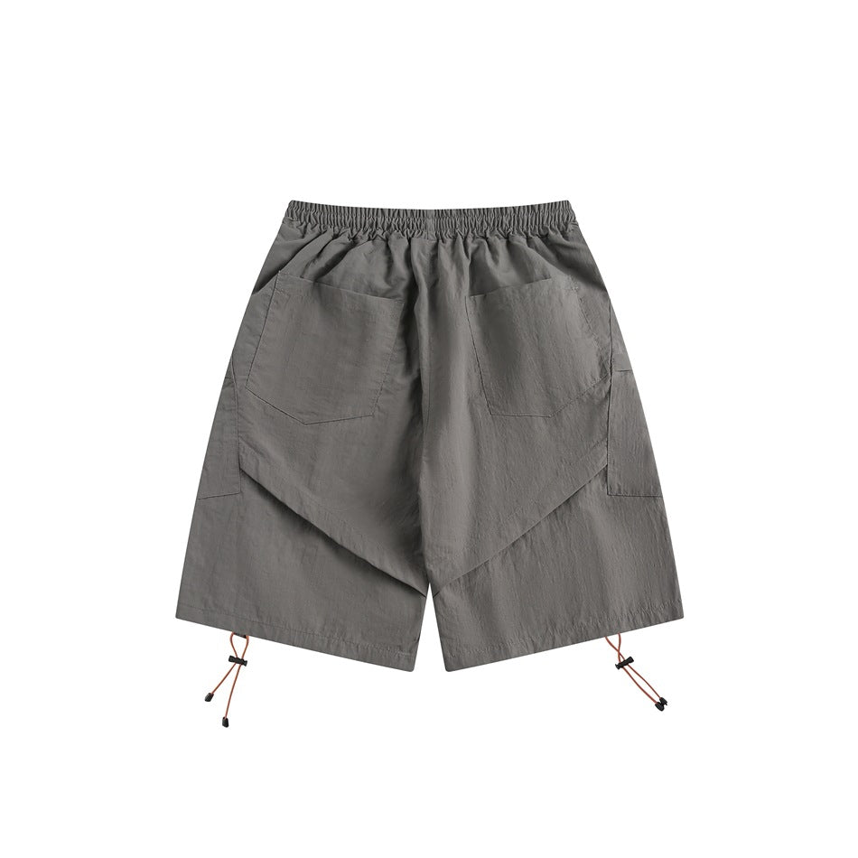 Back view of gray shorts with an elastic waist, two patch pockets, and adjustable cords at the hems.