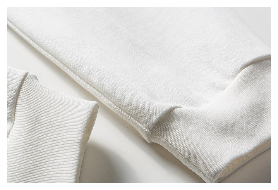 Close-up of a white garment with a wide ribbed cuff or hem.