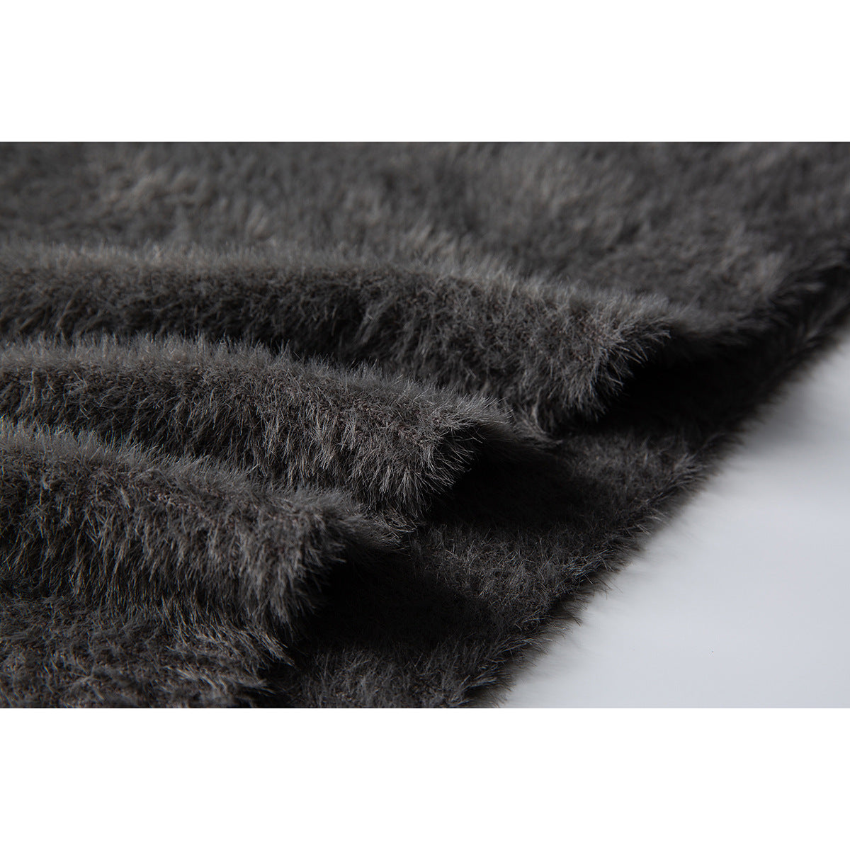 Close-up of the fuzzy charcoal-gray sweater's layered ribbed hem and knit texture.