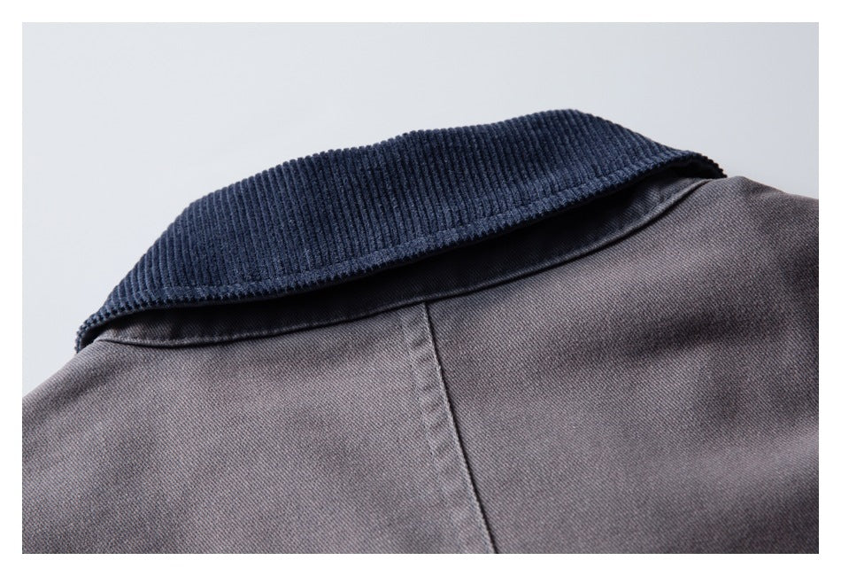 Close-up of a gray garment with a dark navy ribbed collar and visible back seam.