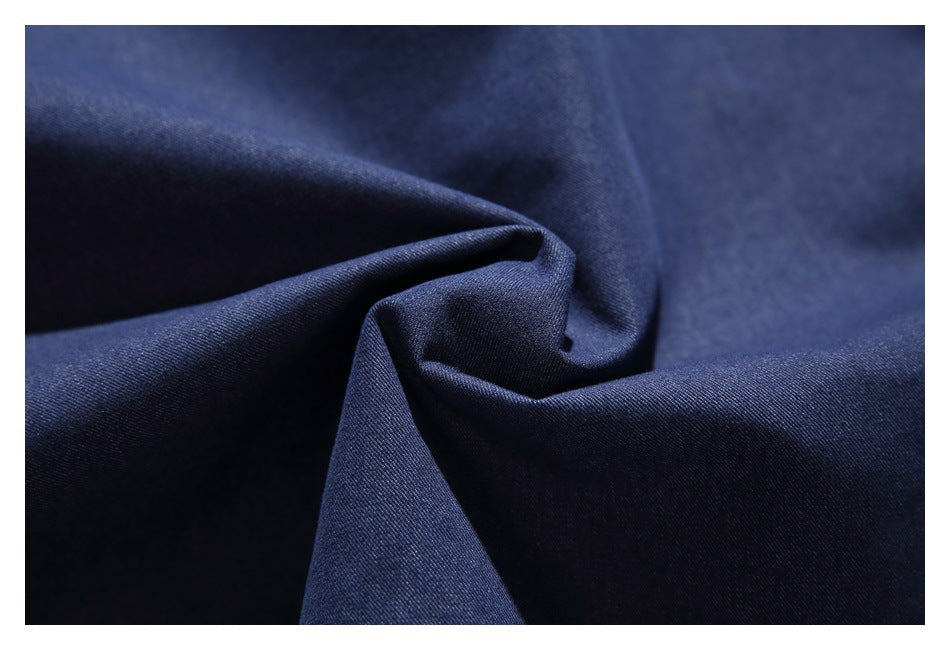Close-up of dark navy fabric gathered into soft folds.
