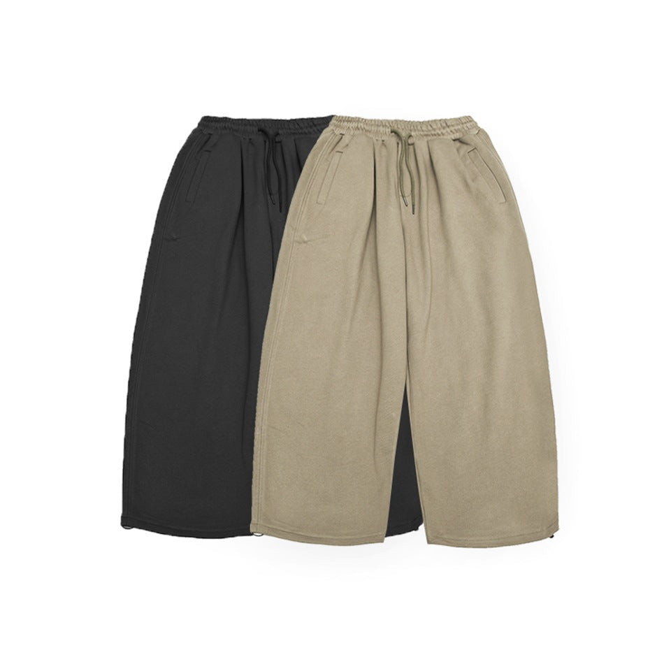 Two pairs of wide-leg drawstring pants shown together in charcoal and taupe.