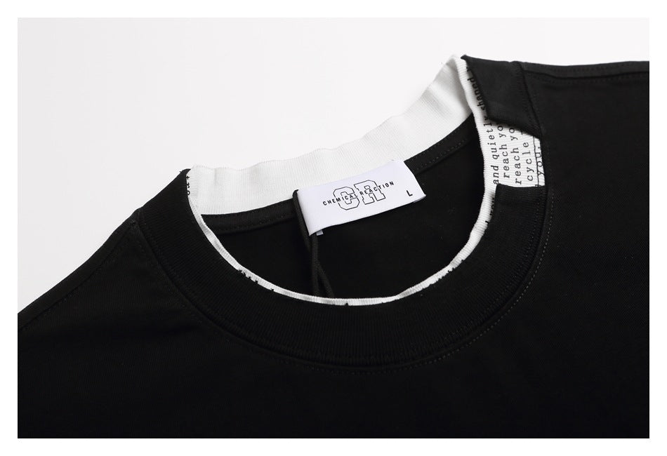 Close-up of a black T-shirt's crew neck, white inner trim, and size label.