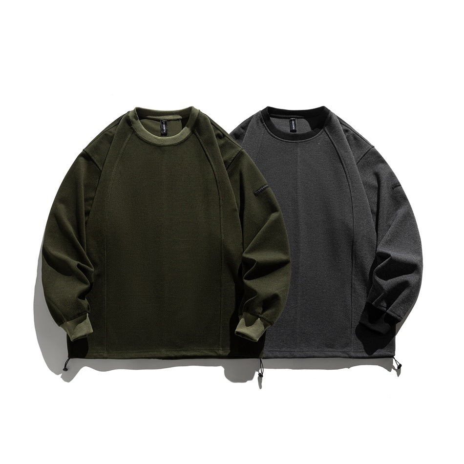 Two crewneck sweatshirts shown flat in olive and charcoal gray, with raglan sleeves and adjustable hem cords.