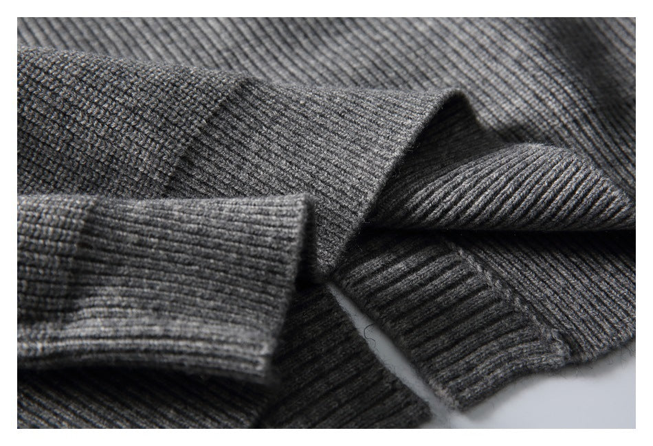 Close-up of gray rib-knit sweater fabric and folded ribbed edges.