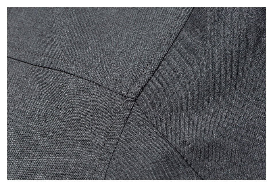 Close-up of charcoal fabric showing intersecting stitched seams.