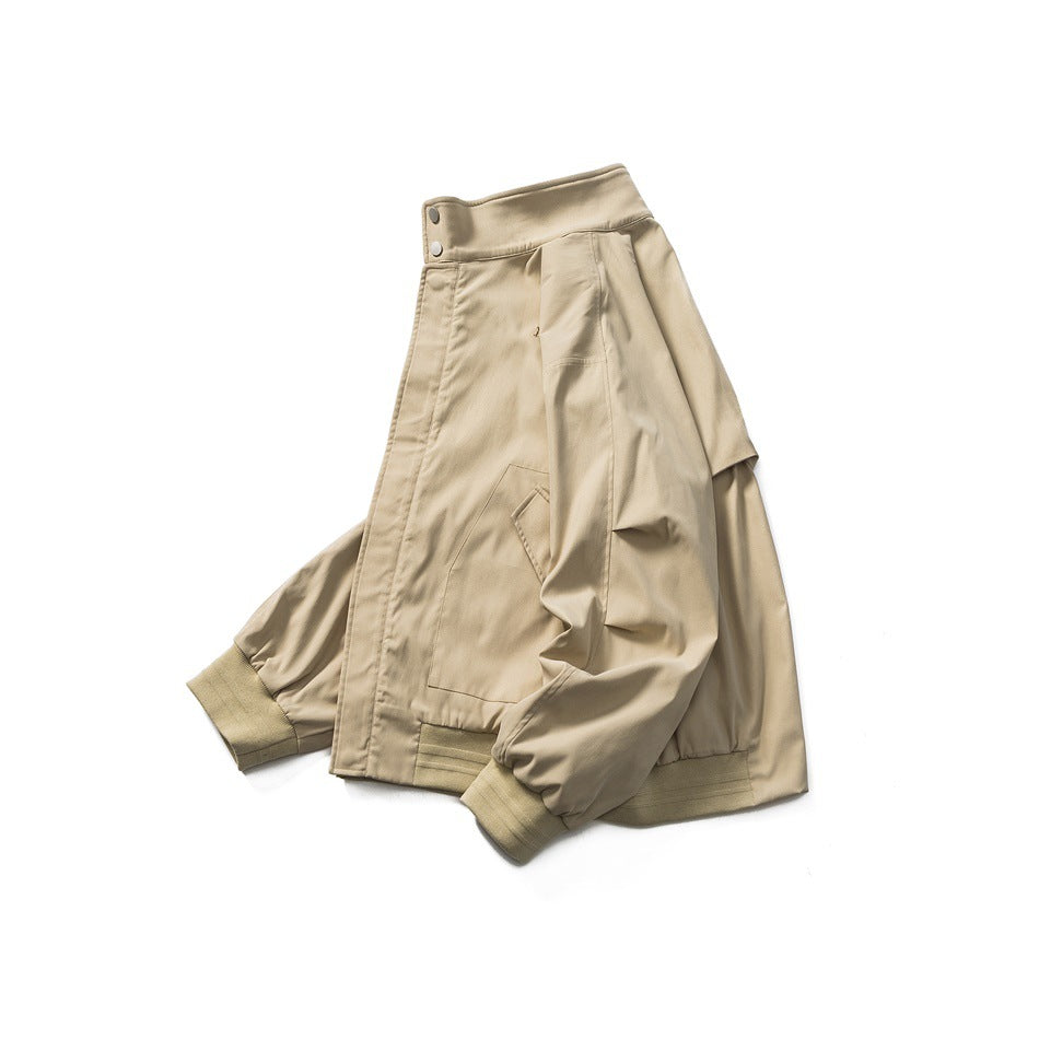 Tan jacket shown at an angle, with a high snap-button collar, front pockets, and ribbed cuffs and hem.