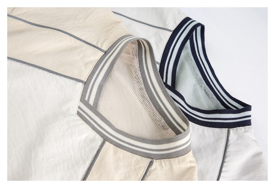 Close-up of two pullover necklines showing striped rib trim and mesh lining in cream-gray and white-navy colorways.