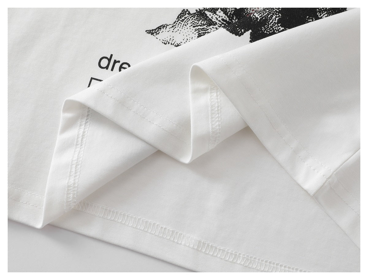 Close-up of the white T-shirt's folded hem, showing stitching and overlocked seams.