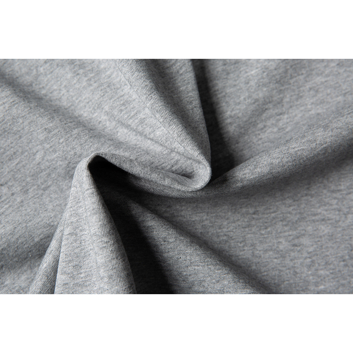 Macro view of heather gray fabric gathered into soft folds.