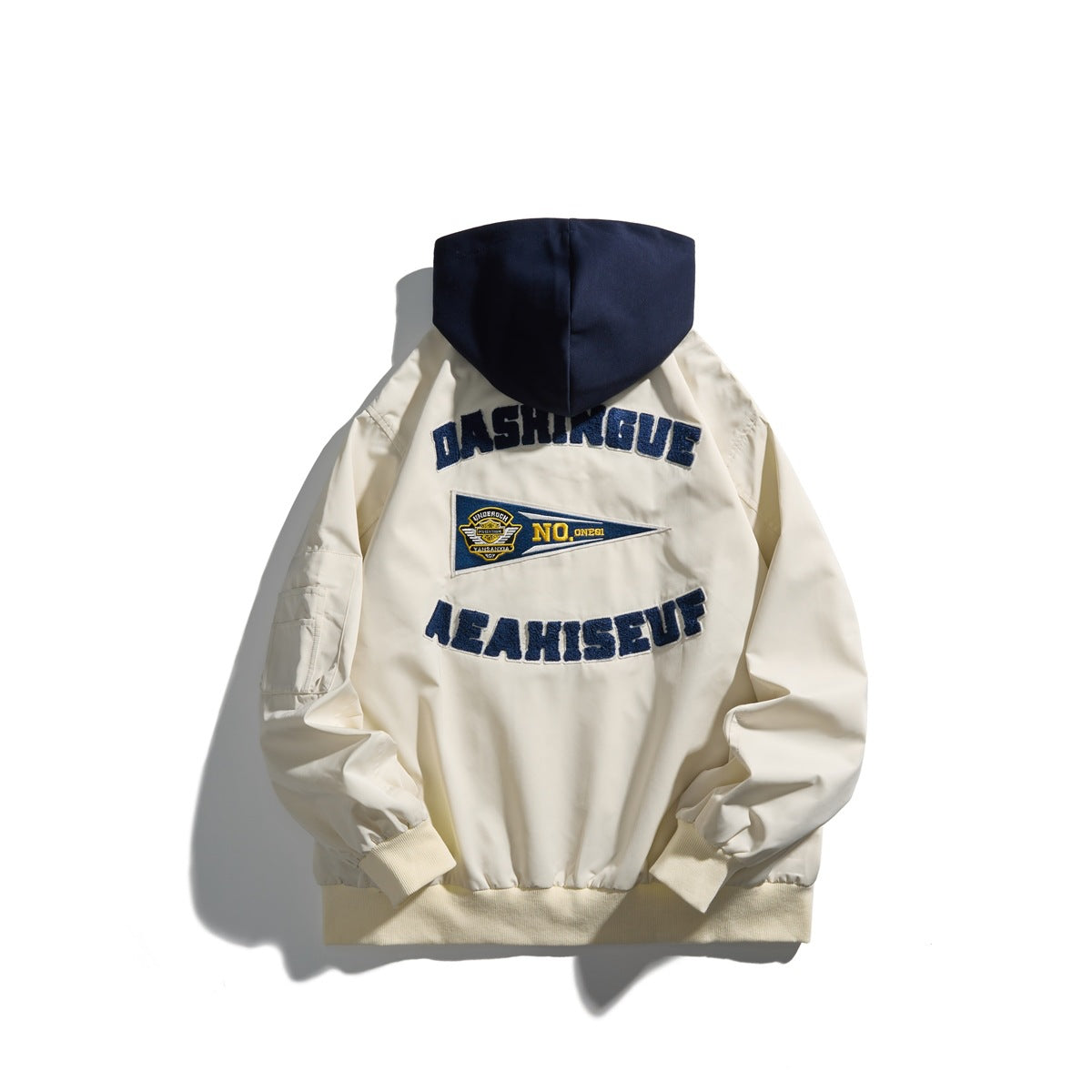 Back of beige zip hooded jacket with navy hood, embroidered navy lettering and pennant patch, ribbed hem and cuffs