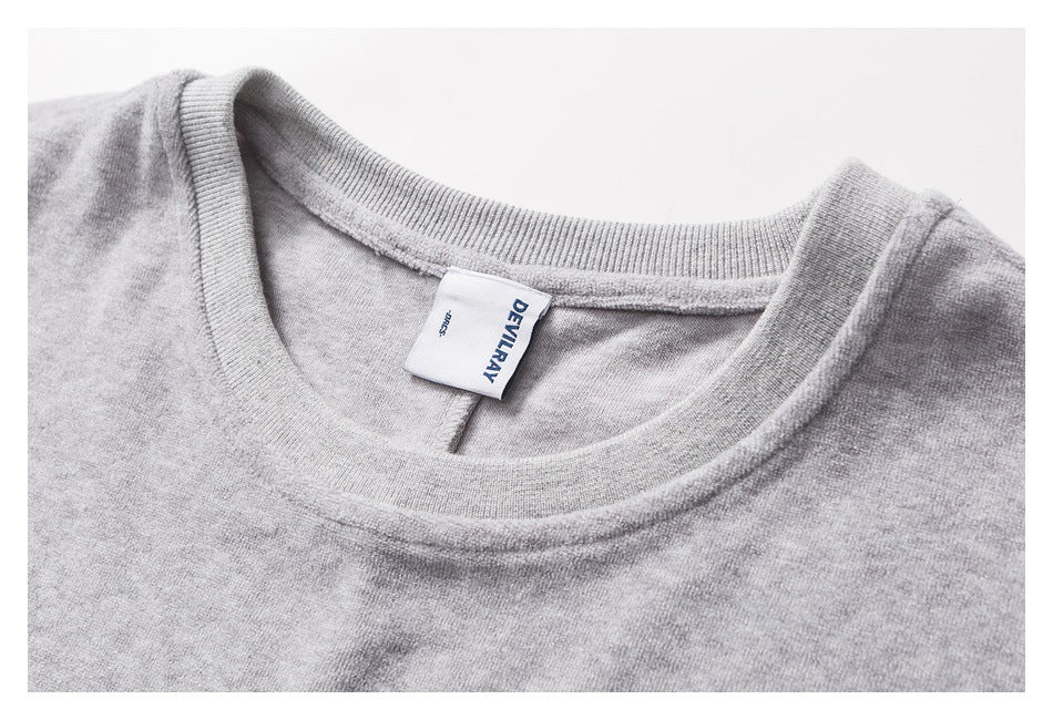 Close-up of a heather-gray crew neck and sewn-in DEVILRAY label.