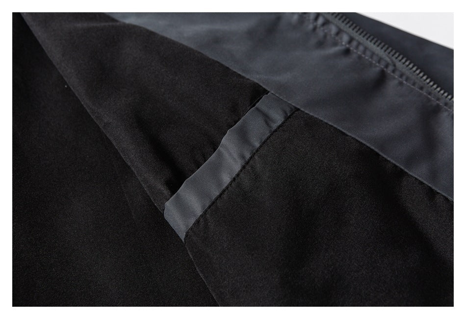 Close-up of a black jacket interior showing a soft dark lining, zipper, and stitched fabric trim.