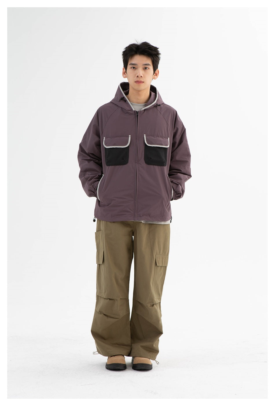Model wearing the dusty purple hooded zip jacket with olive cargo pants, front view