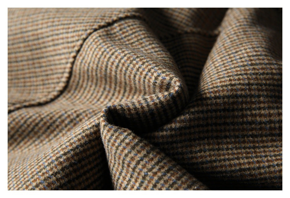 Close-up of folded brown, tan, and blue checked fabric showing its woven pattern.