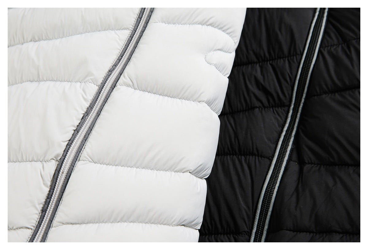 Close-up of white and black quilted puffer jackets with contrasting front zippers.