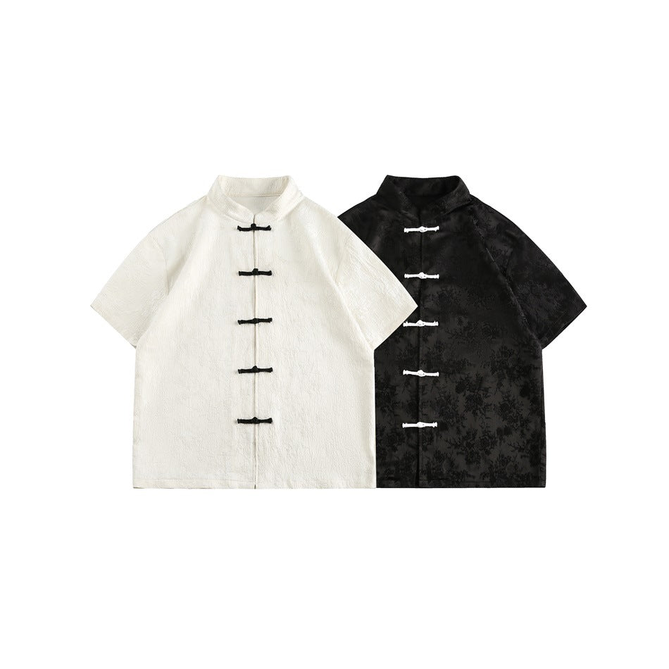 Ivory and black short-sleeve mandarin-collar jackets with contrasting frog closures, shown side by side from the front.
