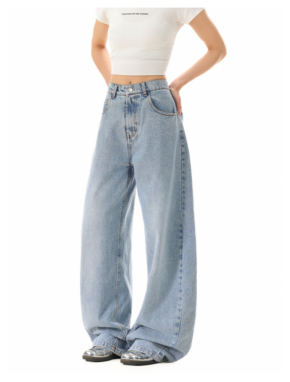 Model wearing light-blue wide-leg barrel jeans with one hand on hip, angled side view