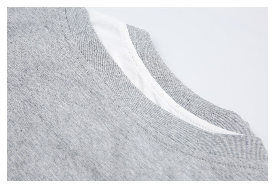 Close-up of a heather-gray crew neckline with white fabric visible underneath.