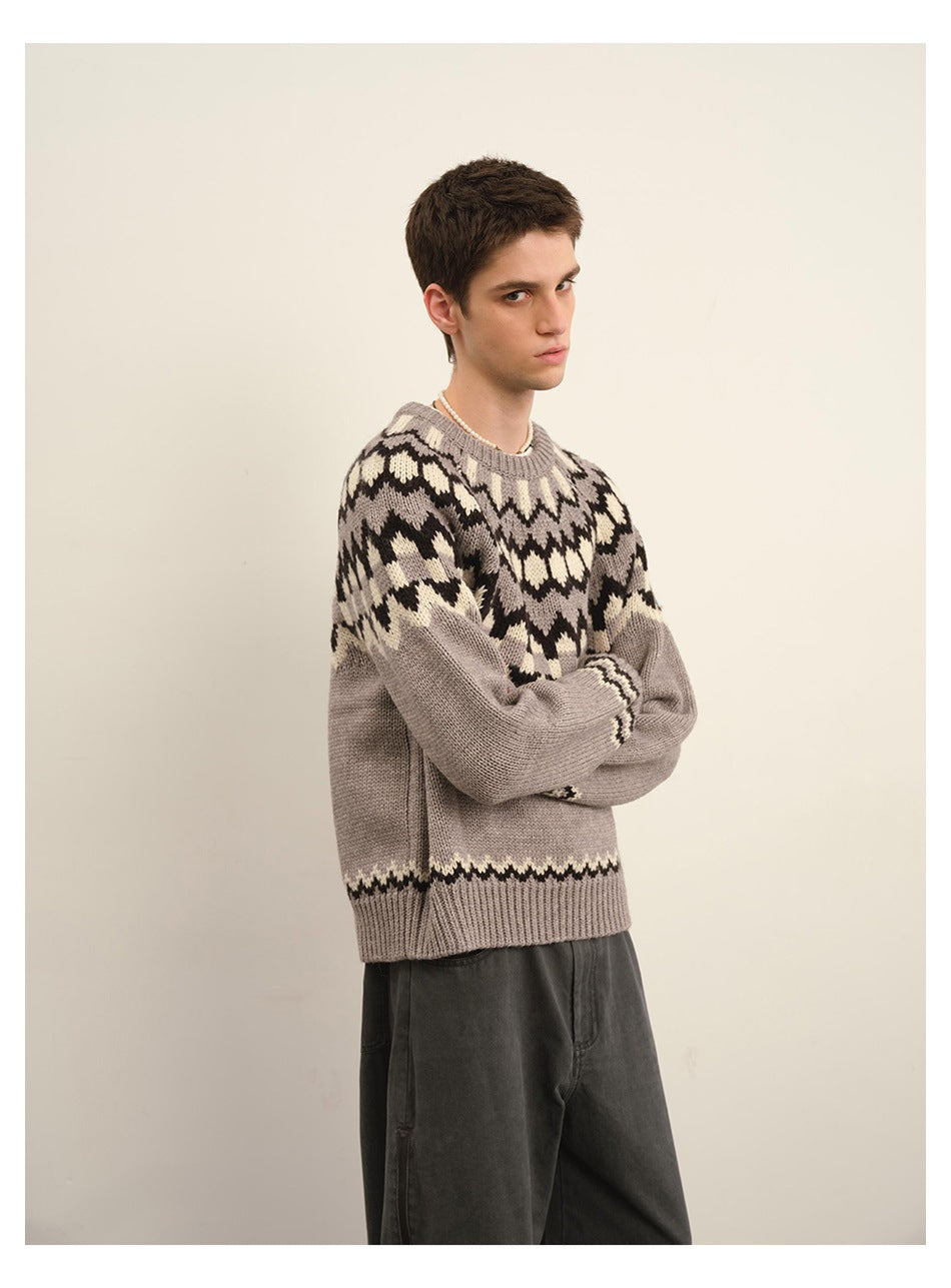 Three-quarter view of a model wearing a taupe Fair Isle sweater with dark and cream patterning.