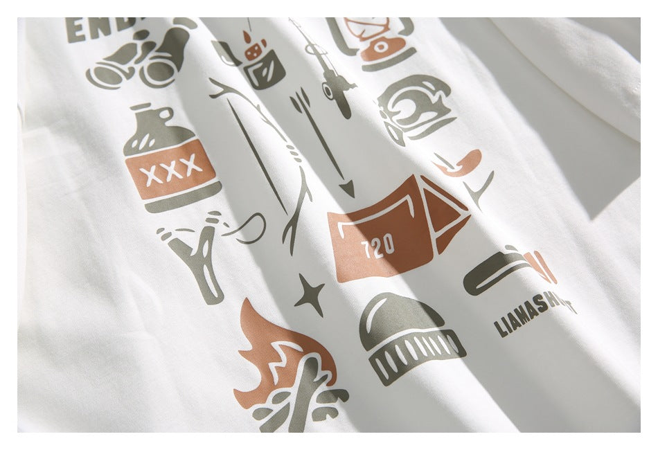 Close-up of the white T-shirt’s outdoor-themed print, including camping and fishing illustrations.