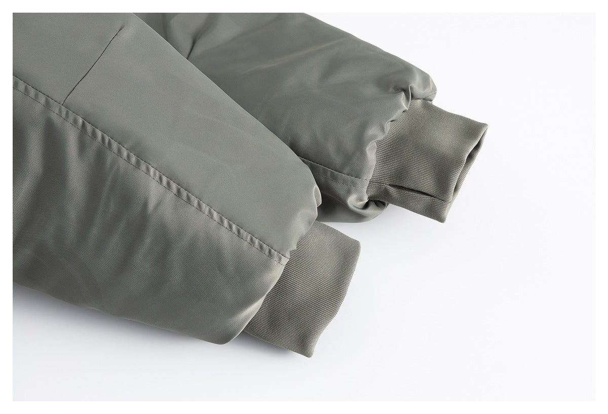 Close-up of two olive-gray jacket sleeve ends with textured ribbed cuffs.