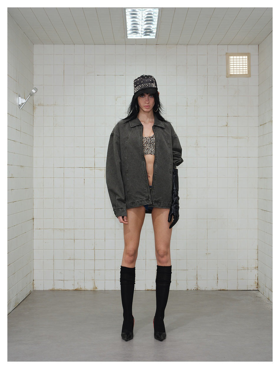 Front view of a model wearing an oversized charcoal washed jacket over a leopard-print top.