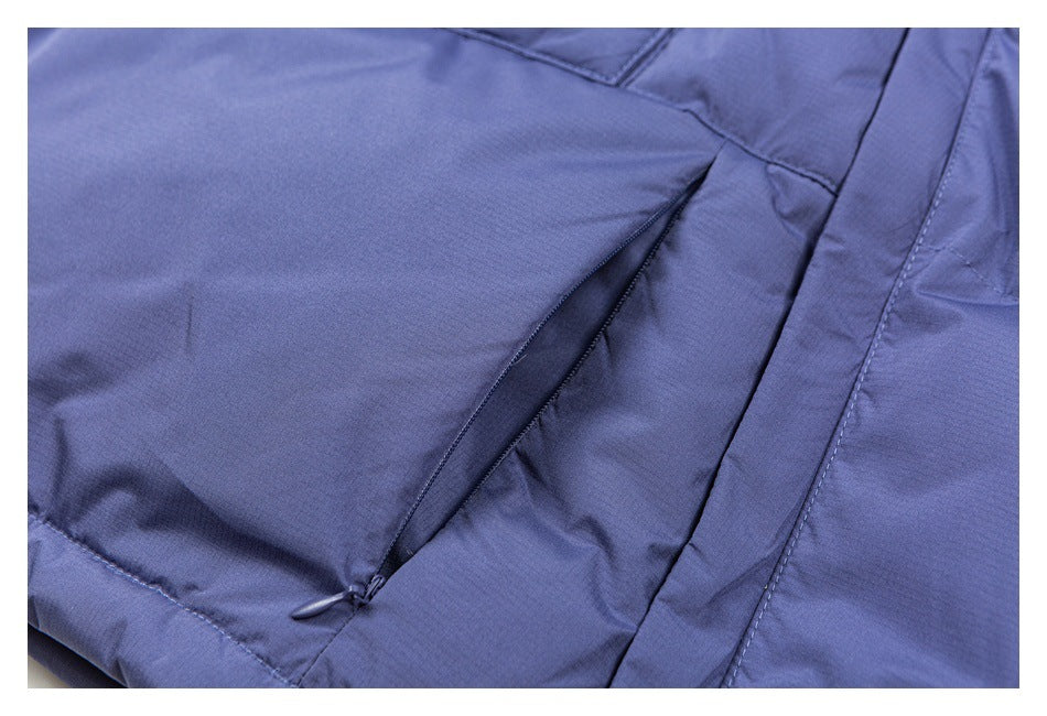 Close-up of a diagonal zippered pocket on a periwinkle garment.