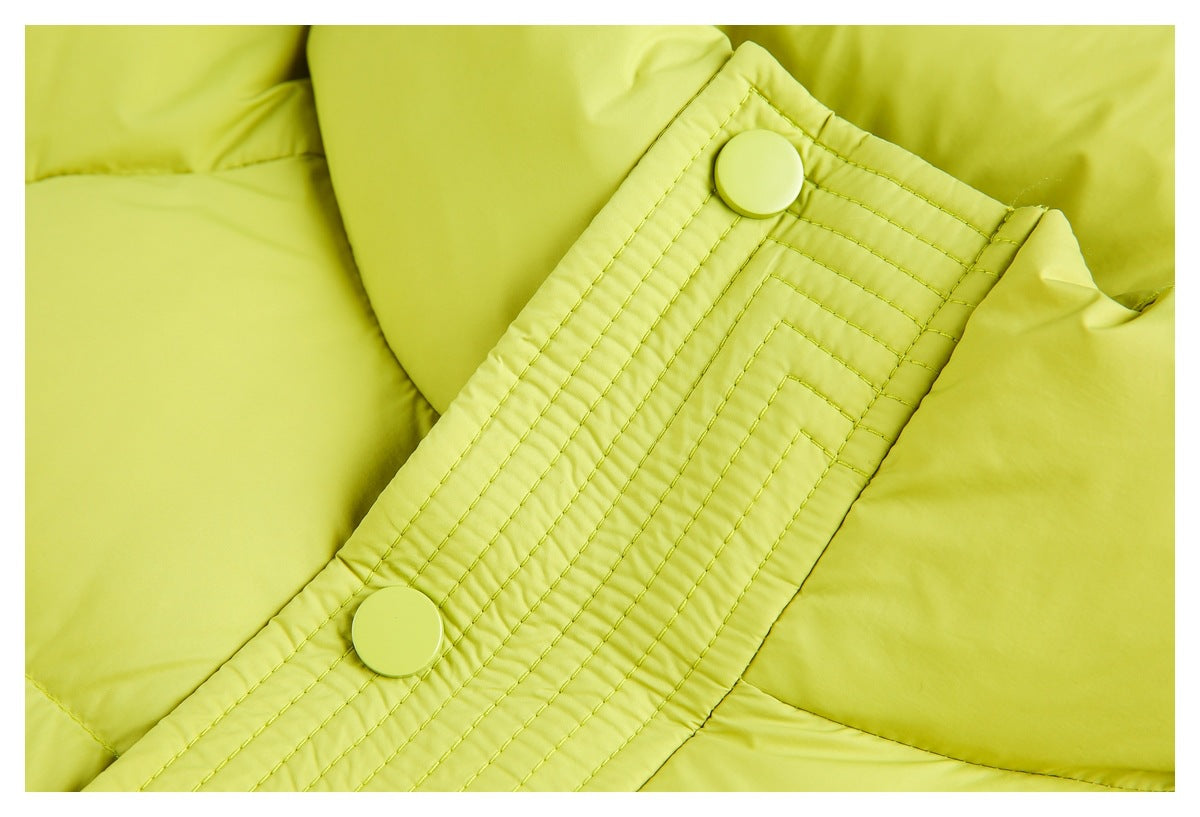 Close-up of a lime-green jacket's snap-button placket with parallel decorative stitching.