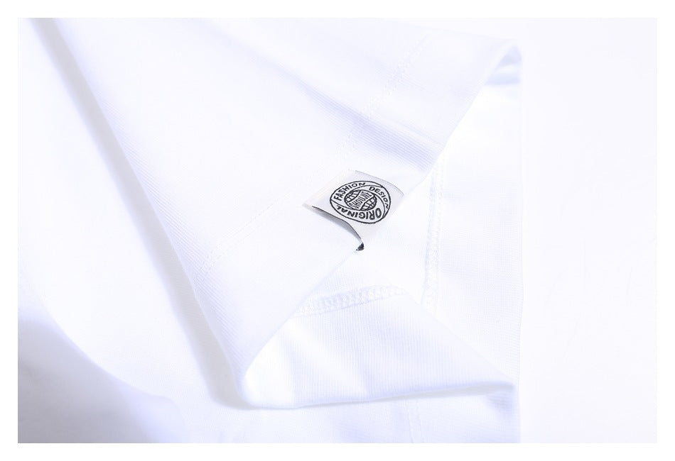 Close-up of a white T-shirt seam and a small sewn label with a circular English design.