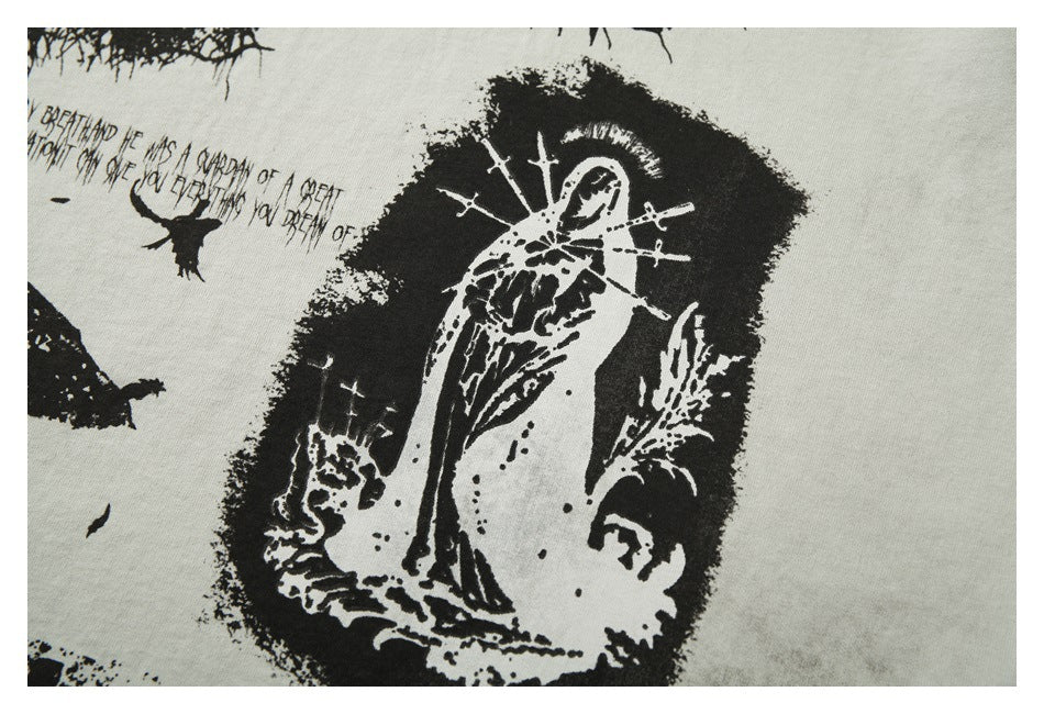 Close-up of a black distressed illustration and small English text printed on off-white fabric.
