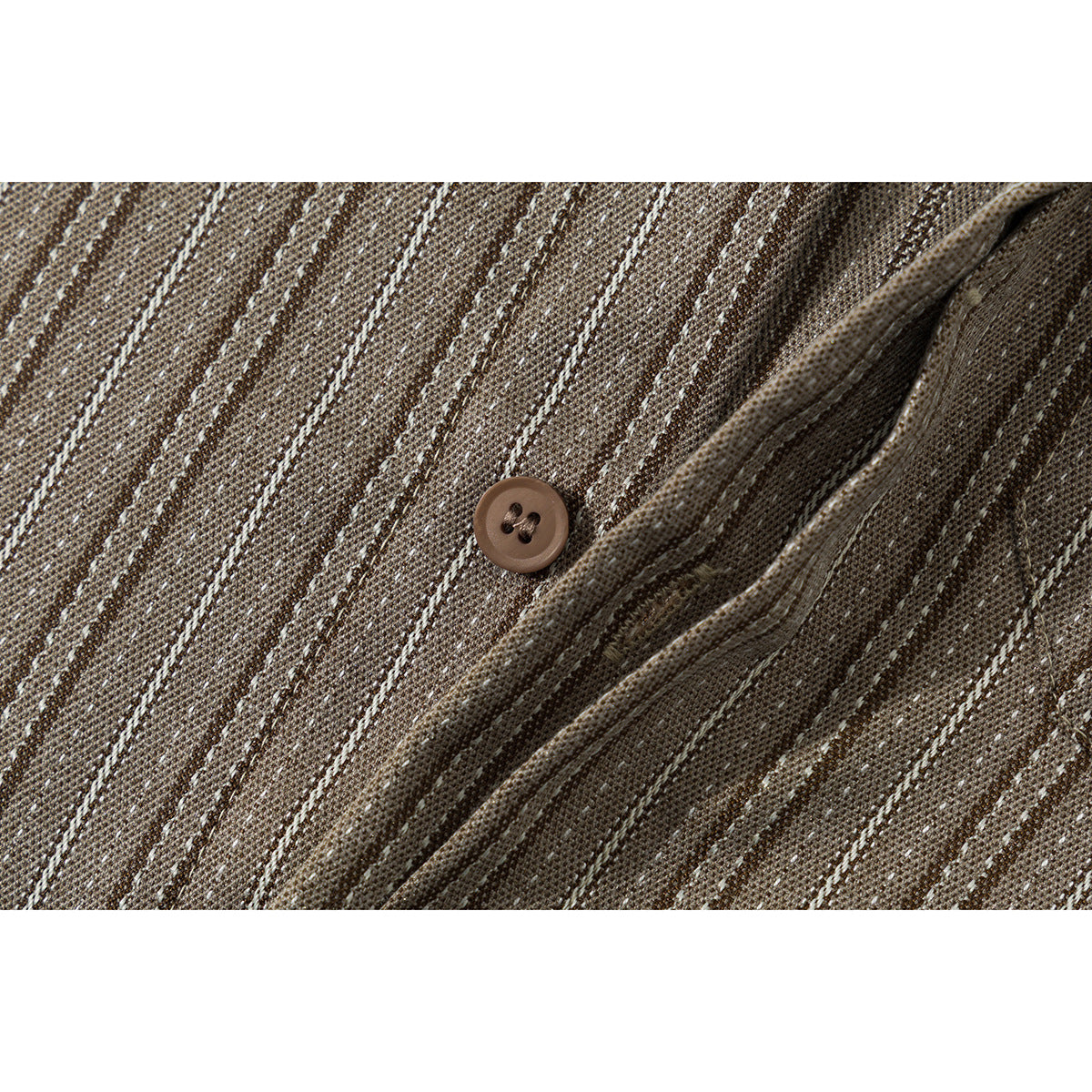 Close-up of a brown four-hole button and placket on a striped shirt.