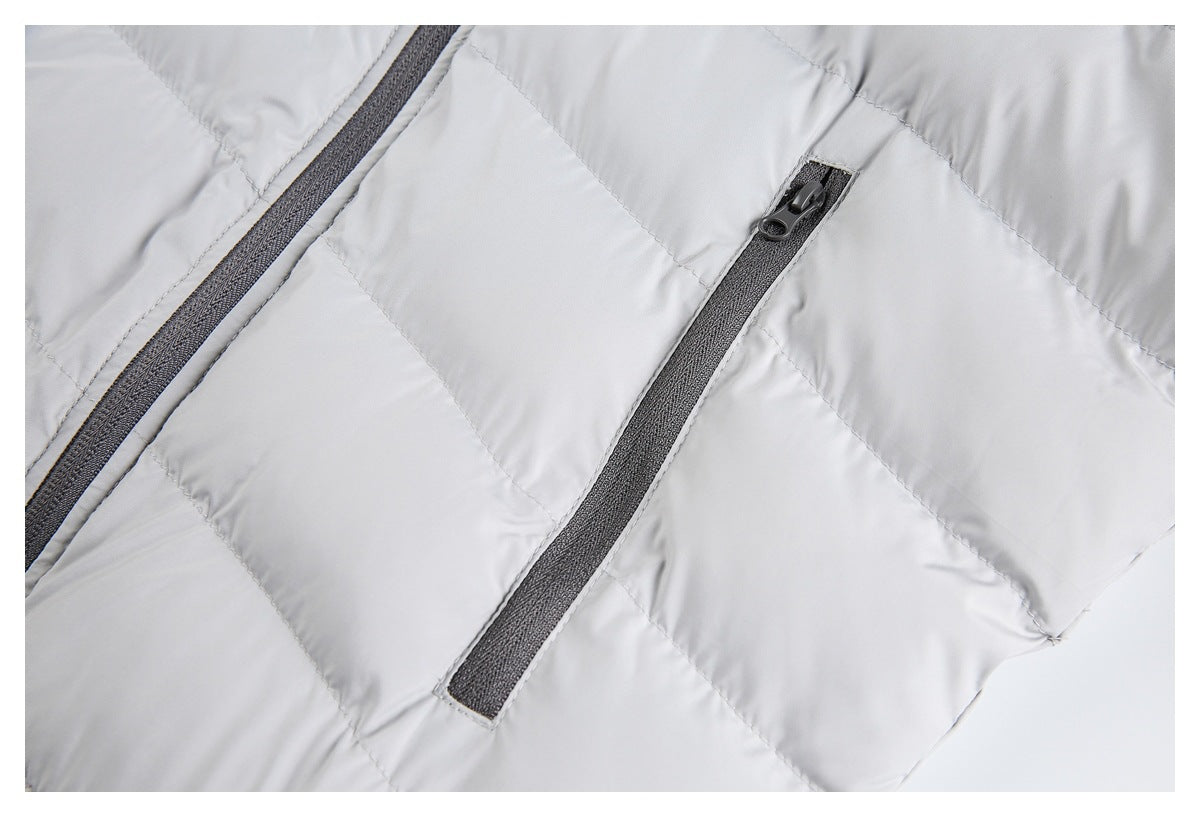 Close-up of a dark zippered pocket on the light gray quilted jacket.