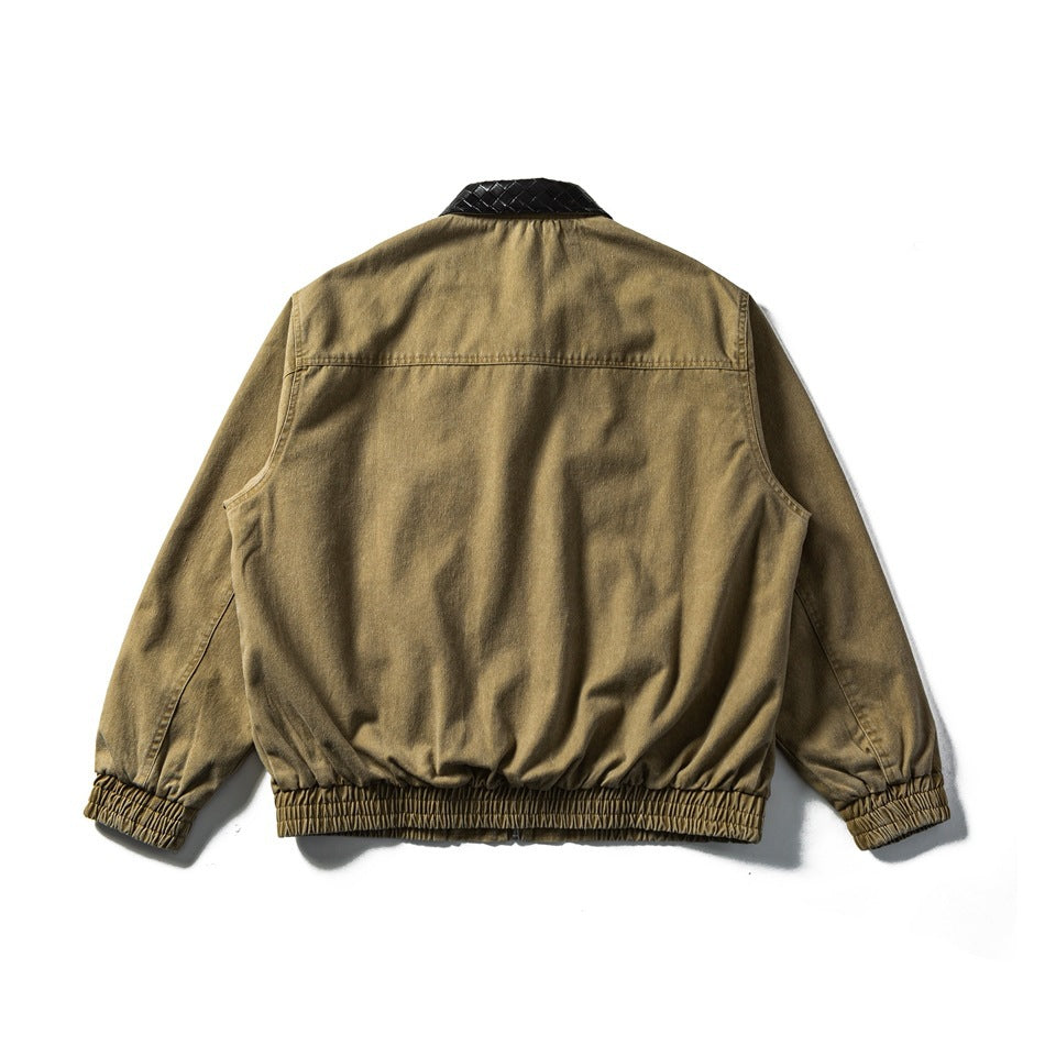 Back view of khaki jacket showing yoke seam, black woven-pattern collar and elasticated hem and cuffs, flat lay