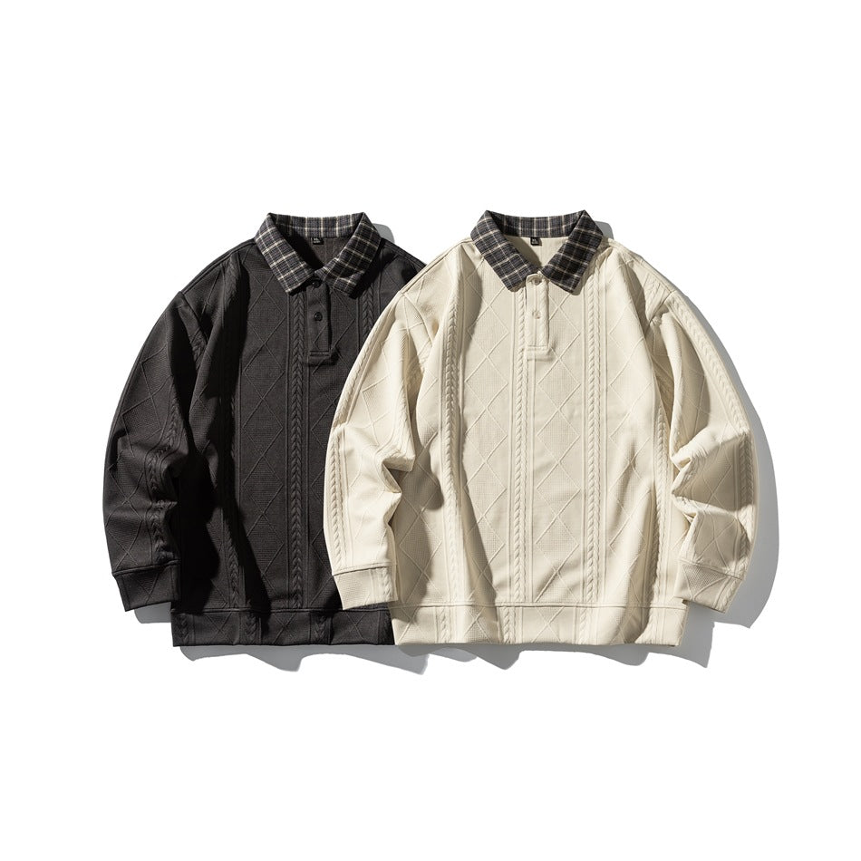 Black and ivory pullovers displayed together, each with a plaid collar, button placket, and raised cable and diamond