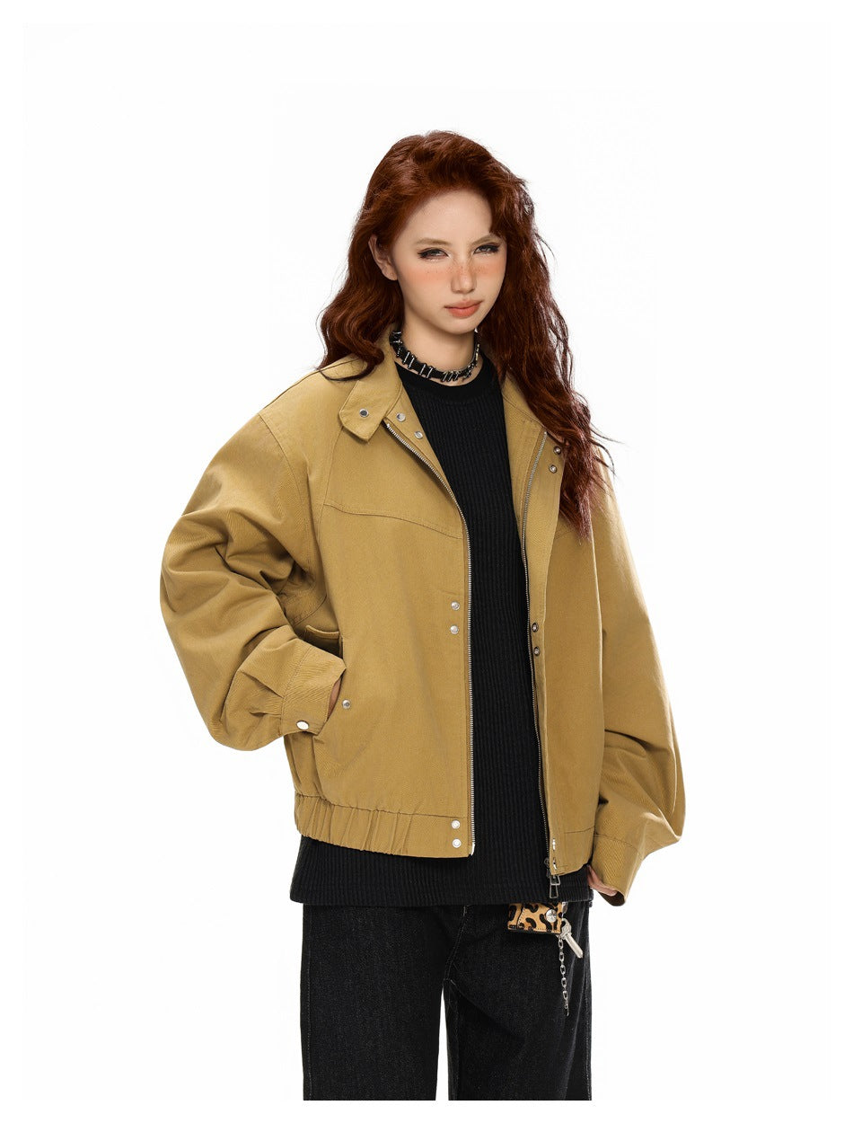Model wearing an open khaki zip bomber jacket with snap details over a black knit top and dark jeans