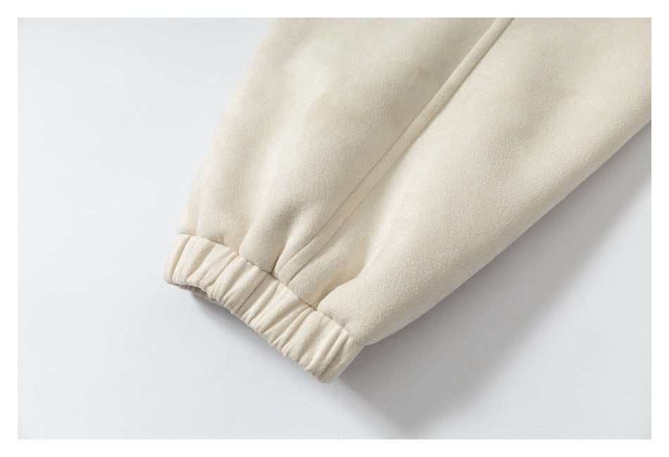 Close-up of a cream sleeve ending in an elasticized cuff.