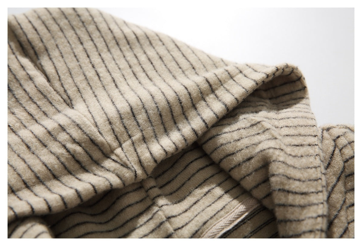 Close-up of the beige garment's striped hood, inner facing, and seam.