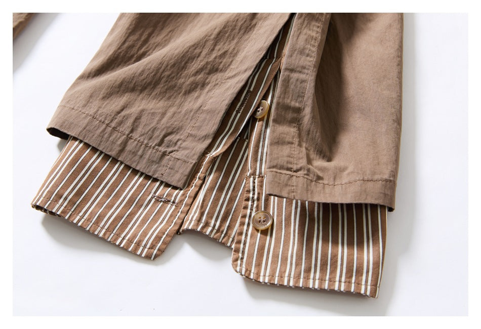 Close-up of a tan garment showing brown-and-white striped lining, stitching, and buttons.