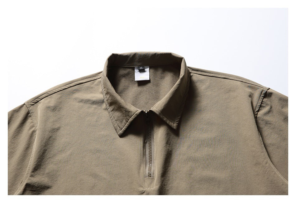 Cropped front view of a taupe collared top with a short center zipper.