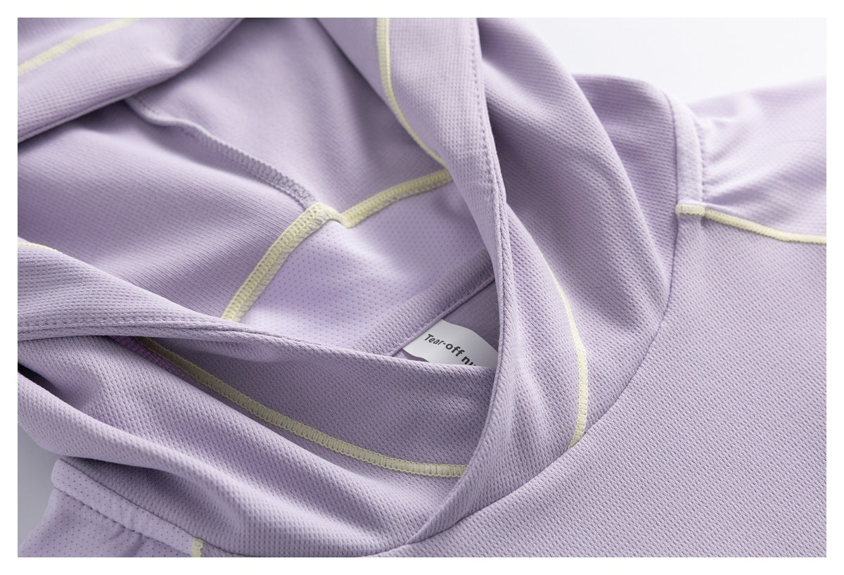 Close-up of the lavender hood interior, mesh fabric, pale yellow stitching and a partially visible tear-off label.