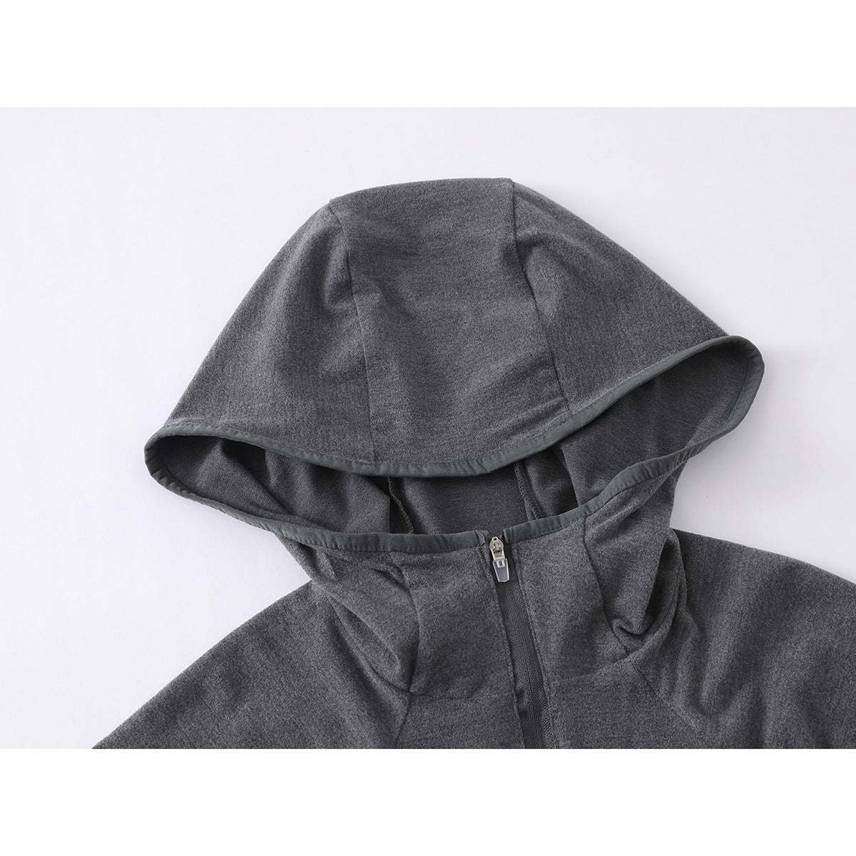 Close-up of a charcoal gray hood and upper chest of a zip-front top, showing the hood seams and zipper.