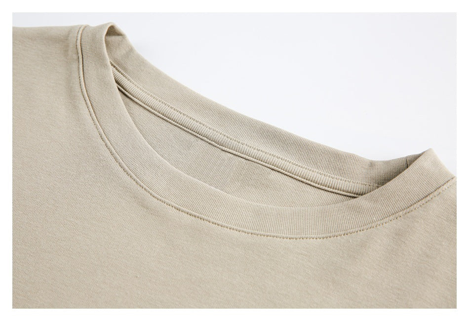 Close-up of a beige crew neckline and ribbed collar with visible stitching.